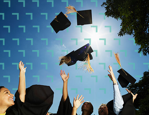 graduates throwing their caps into the air