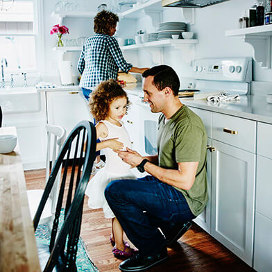 father talking to daughter in kitchen