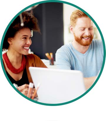 A man and woman smiling while at work