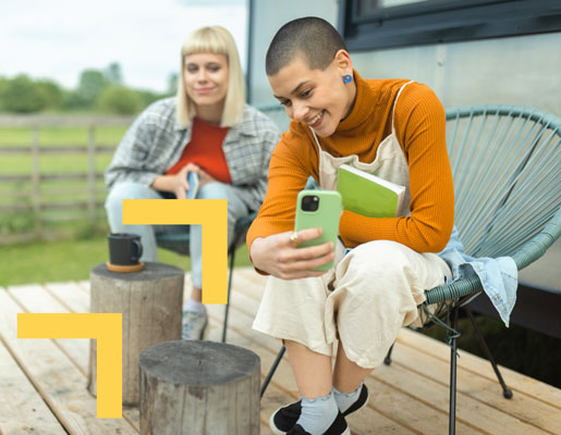 A person sitting on a chair, snapping a photo of something off-frame