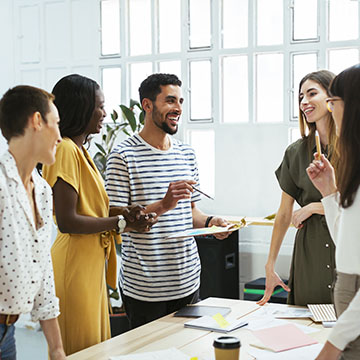 People standing around a table talking