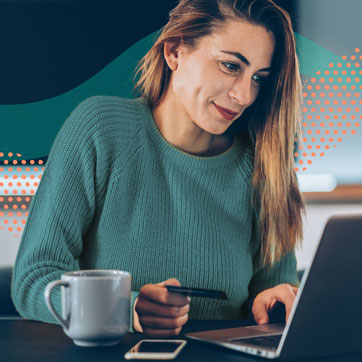 woman entering credit card information on laptop